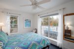 Second bedroom offers a queen bed and flat screen tv with deck, backyard and pool views.